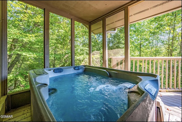 sunroom / solarium with a hot tub