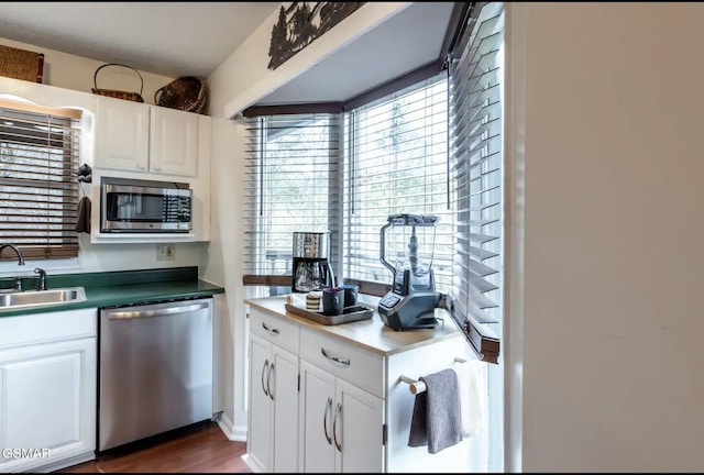 kitchen featuring white cabinets, dark hardwood / wood-style flooring, sink, and stainless steel appliances