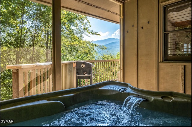 interior space with a mountain view and a jacuzzi