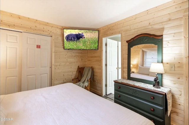 bedroom with a closet and wooden walls