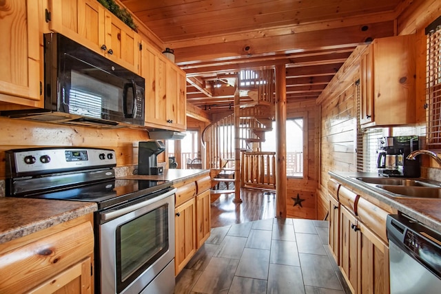 kitchen featuring wooden walls, dark wood-style flooring, a sink, appliances with stainless steel finishes, and wooden ceiling