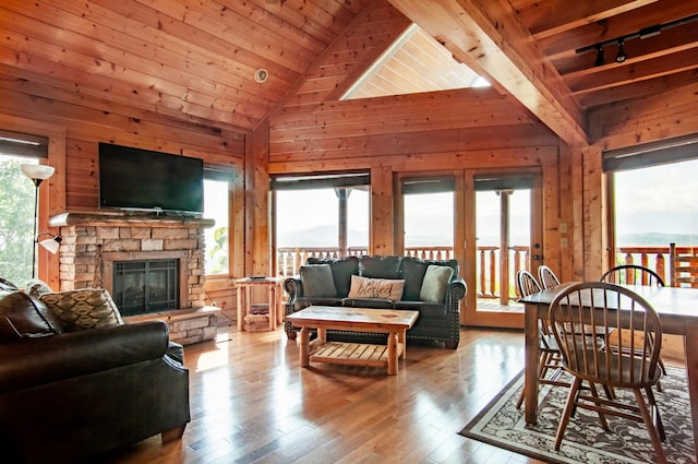 interior space with a wealth of natural light, wood walls, and wood ceiling