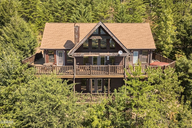 rear view of house featuring a deck