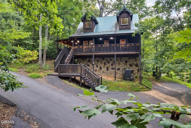 1502 Sky View Dr, Sevierville, TN 37876 - view of front facade featuring stone siding, stairway, and a metal roof