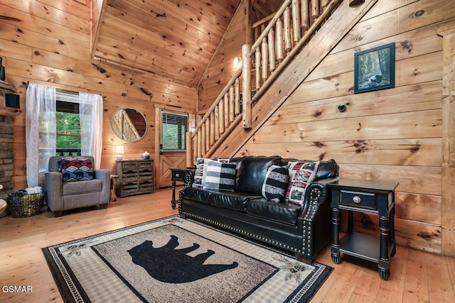 1502 Sky View Dr, Sevierville, TN 37876 - living room with lofted ceiling, light wood-style floors, stairway, and wood walls