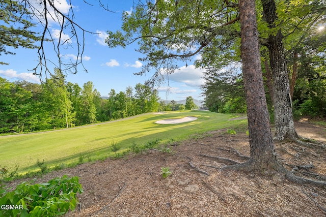 view of home's community featuring a yard and golf course view