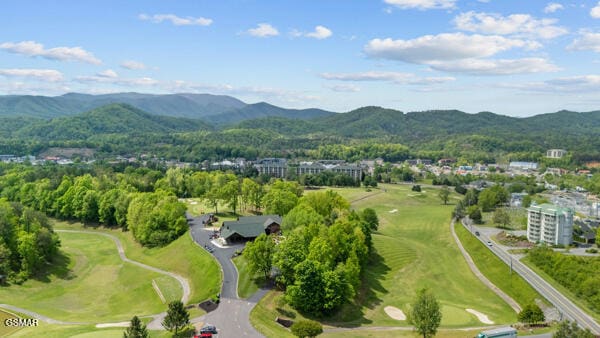 drone / aerial view featuring a mountain view and golf course view