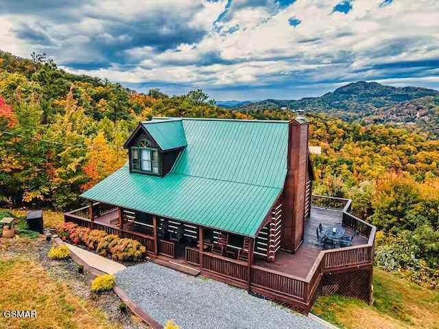 3933 Glenview Way, Sevierville, TN 37862 - view of front of home with a chimney, metal roof, a view of trees, and a deck with mountain view