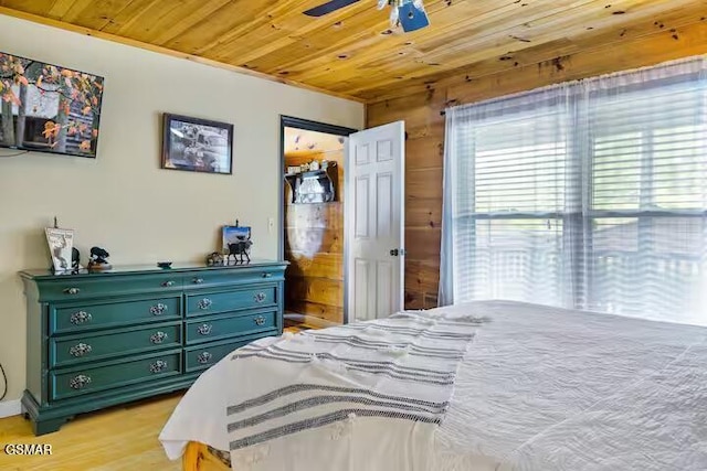 3933 Glenview Way, Sevierville, TN 37862 - bedroom with wooden ceiling, wooden walls, light wood-style flooring, and a ceiling fan
