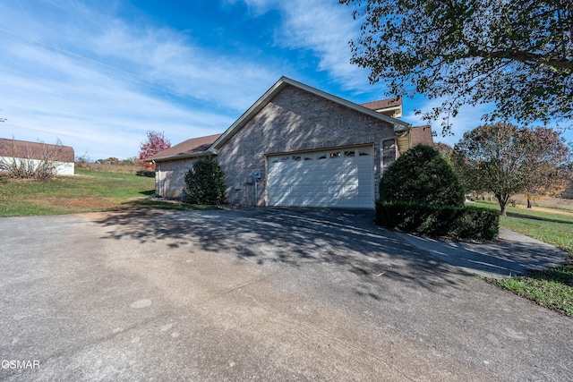 view of home's exterior featuring driveway and an attached garage