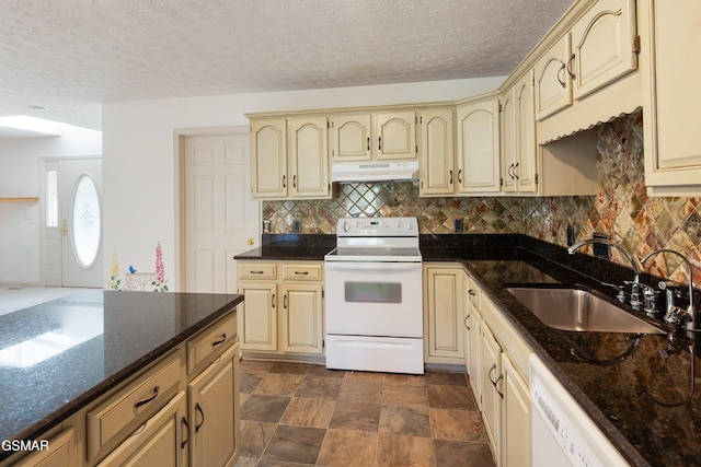 kitchen featuring white appliances, a sink, under cabinet range hood, cream cabinets, and backsplash