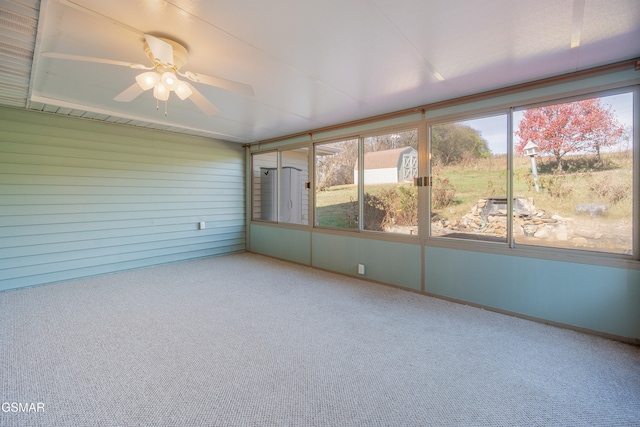 unfurnished sunroom with a ceiling fan