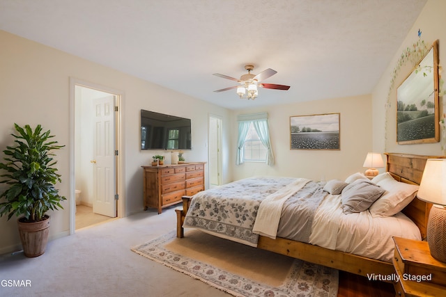 bedroom featuring connected bathroom, a ceiling fan, and carpet