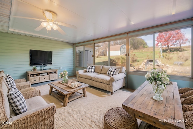 sunroom / solarium with a ceiling fan