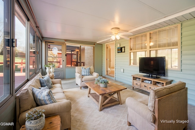 living room featuring wooden walls and ceiling fan