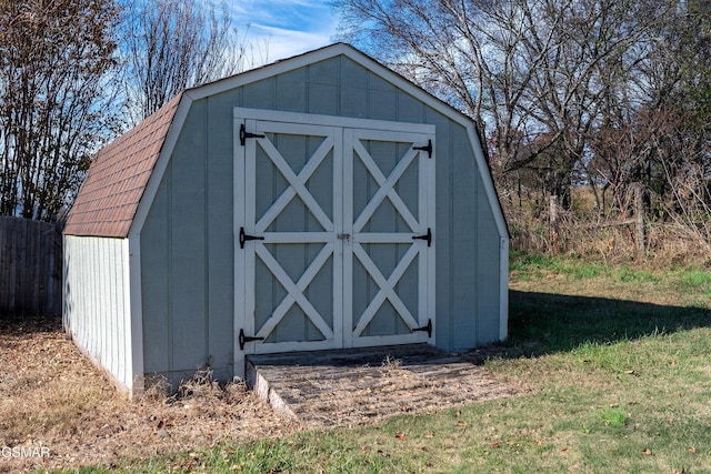 view of shed featuring fence