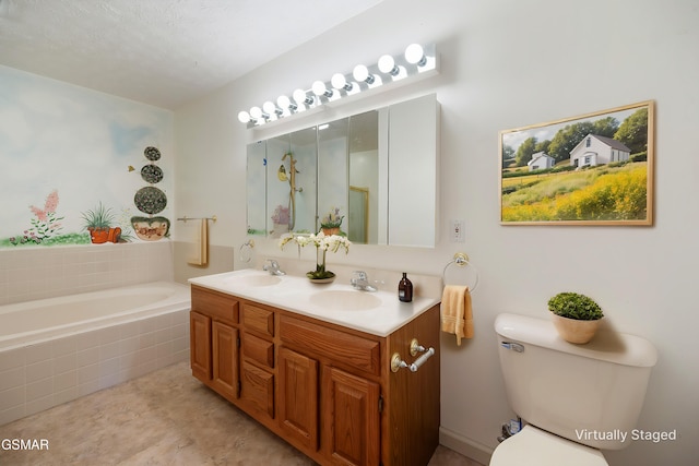 bathroom with a garden tub, toilet, double vanity, and a sink