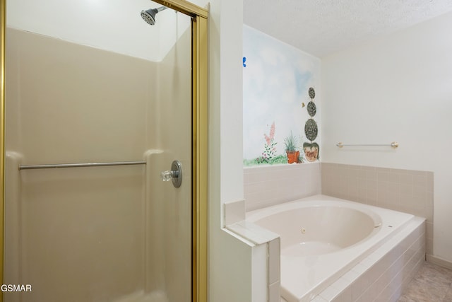 full bathroom featuring a textured ceiling, a bath, and a shower stall