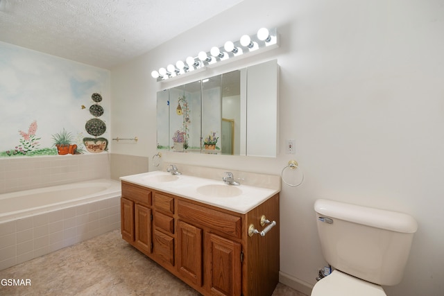 full bathroom with a textured ceiling, a garden tub, toilet, and a sink