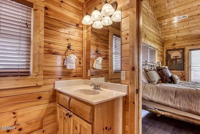 bathroom with lofted ceiling, vanity, wooden ceiling, and wood walls