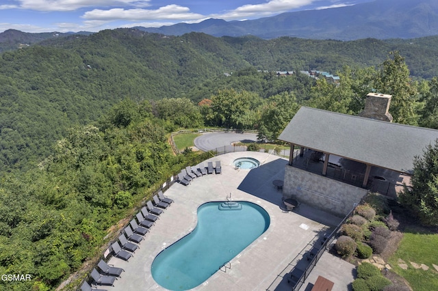 view of swimming pool featuring a mountain view and a patio