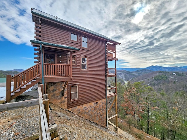 view of side of home with a mountain view