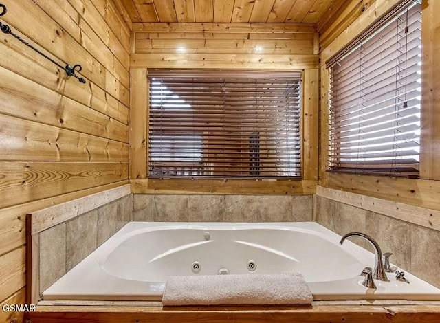 bathroom featuring a bath, wooden ceiling, and wood walls