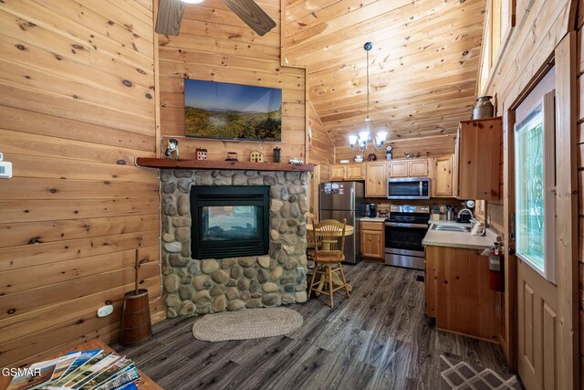 living room featuring wooden walls, a wealth of natural light, dark wood-style flooring, and lofted ceiling