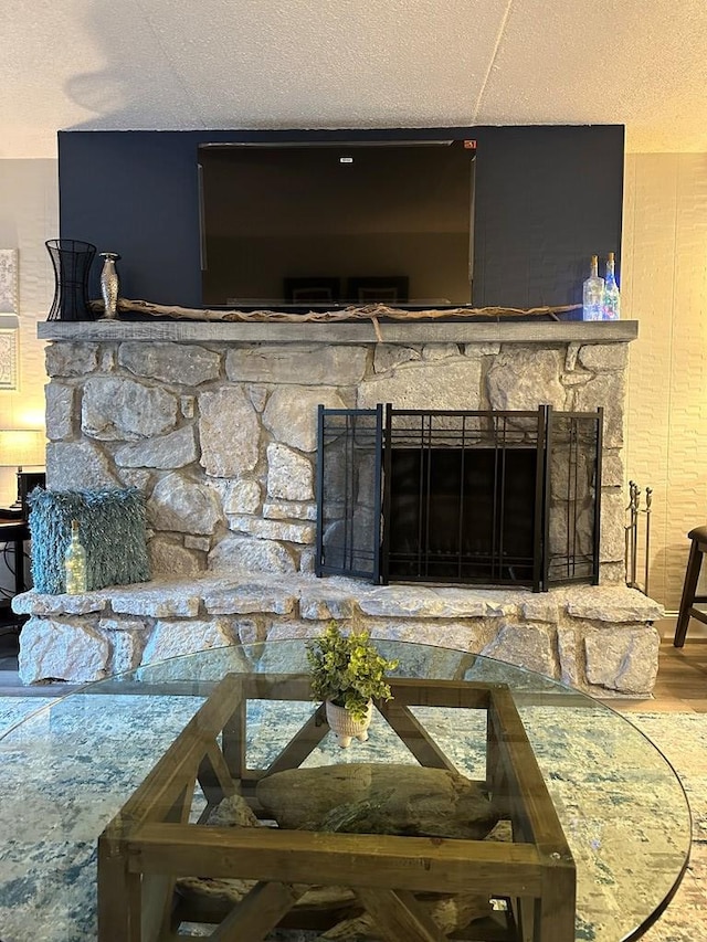 details with a fireplace, hardwood / wood-style floors, and a textured ceiling