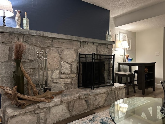 details with a textured ceiling, a fireplace, and hardwood / wood-style flooring