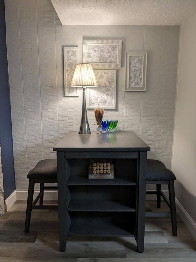 dining room with a textured ceiling and hardwood / wood-style flooring