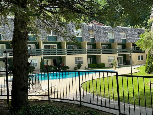 view of swimming pool with a yard and a patio area