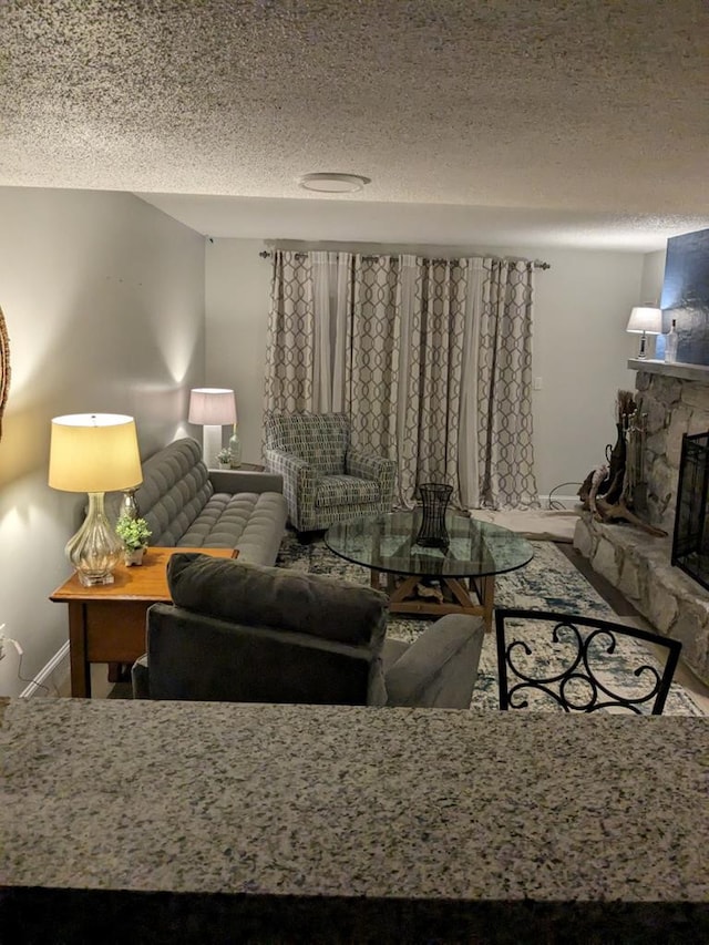 living room with a fireplace and a textured ceiling