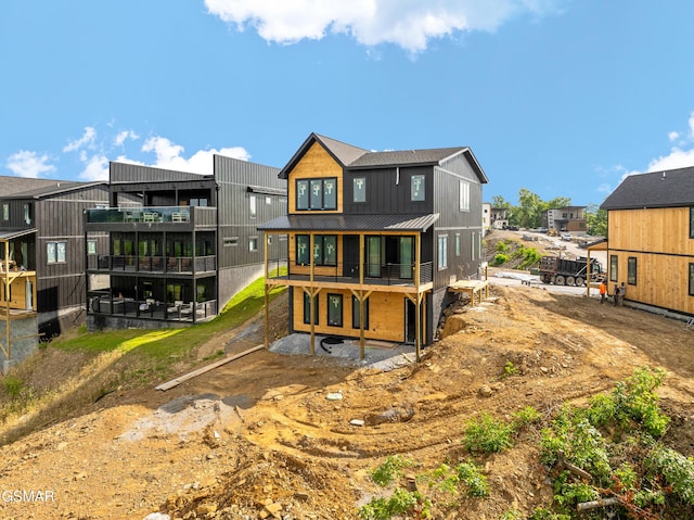 1409 Reedmont Way, Sevierville, TN 37876 - rear view of property with a standing seam roof, a metal roof, a balcony, and a residential view