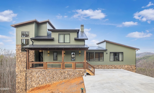 1505 Misty Ct, Sevierville, TN 37862 - view of front of property featuring stone siding, covered porch, a metal roof, and a chimney