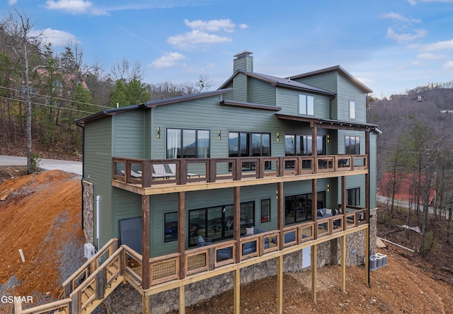 1505 Misty Ct, Sevierville, TN 37862 - rear view of house with a chimney, a deck, and a balcony