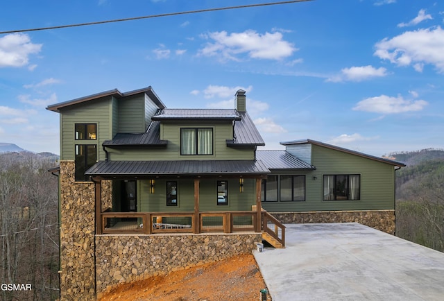 1505 Misty Ct, Sevierville, TN 37862 - back of house featuring a porch, a chimney, a mountain view, and a metal roof