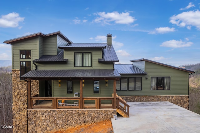 1505 Misty Ct, Sevierville, TN 37862 - view of front facade featuring a porch, a chimney, a metal roof, and stone siding