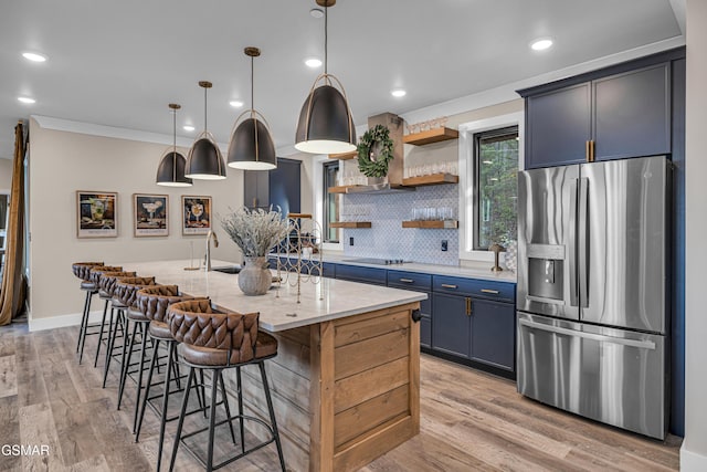 1505 Misty Ct, Sevierville, TN 37862 - kitchen with stainless steel fridge, black electric cooktop, light wood-style flooring, open shelves, and decorative backsplash
