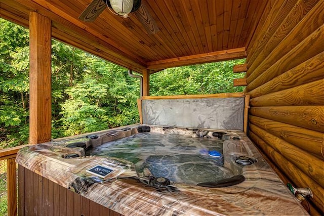 wooden deck featuring a hot tub