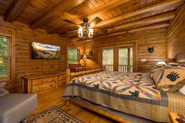 bedroom with hardwood / wood-style floors, wood walls, ceiling fan, beamed ceiling, and wood ceiling