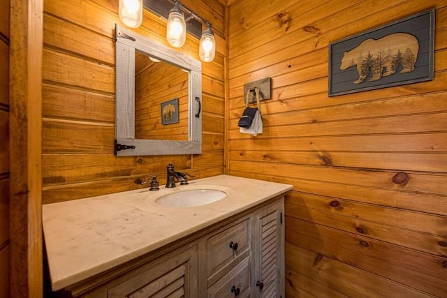 bathroom with vanity and wooden walls