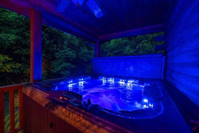 view of swimming pool featuring a hot tub