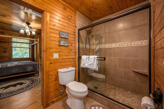 bathroom with wooden ceiling, walk in shower, tile patterned flooring, wood walls, and toilet