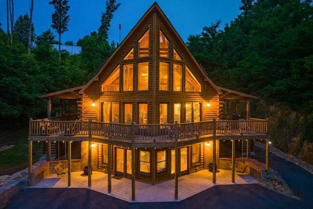 rear view of house with a patio area and a wooden deck