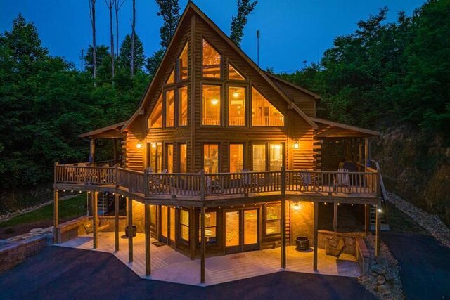 back of property with central AC, a patio area, and a wooden deck