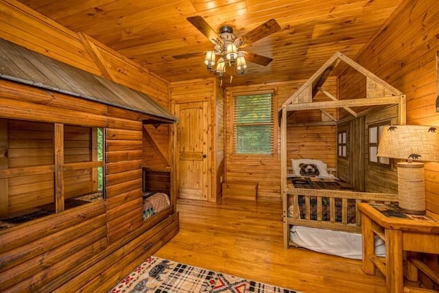 interior space featuring log walls, light hardwood / wood-style flooring, and wood ceiling