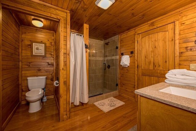 bathroom featuring a shower with shower curtain, toilet, wood ceiling, and wood walls