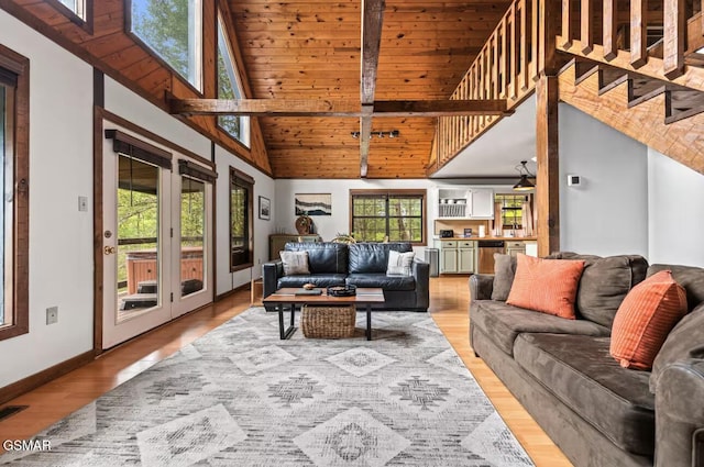 living room featuring high vaulted ceiling and hardwood / wood-style floors