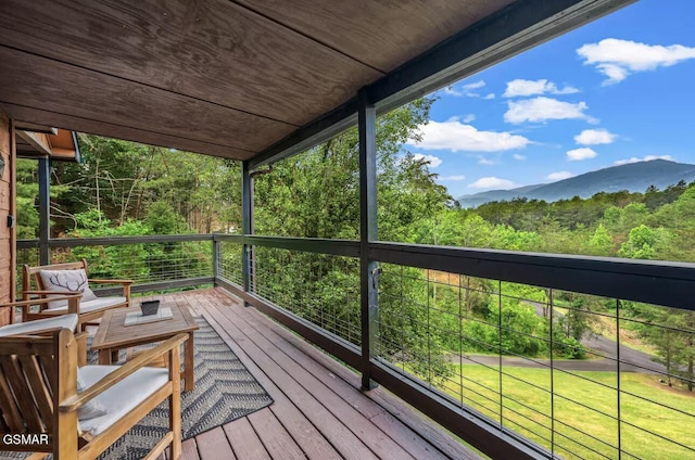 wooden deck with a mountain view